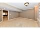 Basement room with built-in bookshelves and an open doorway at 7128 Trail Ridge Ln, Indianapolis, IN 46259