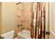 Cozy bathroom features a shower with tiled walls and neutral-colored shower curtain at 7128 Trail Ridge Ln, Indianapolis, IN 46259