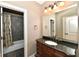 Stylish bathroom with a stone shower, elegant vanity, and modern fixtures at 7128 Trail Ridge Ln, Indianapolis, IN 46259