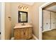 Bathroom featuring a custom vanity with stone countertop, travertine floors, and designer lighting at 7128 Trail Ridge Ln, Indianapolis, IN 46259