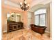 A spacious bathroom features a copper soaking tub, travertine floors, custom vanities, and natural light at 7128 Trail Ridge Ln, Indianapolis, IN 46259