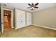 A comfortable bedroom features carpet floors, a ceiling fan, and double closets for ample storage at 7128 Trail Ridge Ln, Indianapolis, IN 46259