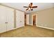 Spacious bedroom with a ceiling fan and double door closets at 7128 Trail Ridge Ln, Indianapolis, IN 46259