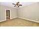 Empty bedroom features a ceiling fan, carpeted floors, and neutral walls at 7128 Trail Ridge Ln, Indianapolis, IN 46259