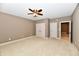 Bedroom featuring neutral walls, a ceiling fan, and double closets at 7128 Trail Ridge Ln, Indianapolis, IN 46259