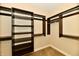 Walk-in closet with custom shelving and hanging rods offers ample storage at 7128 Trail Ridge Ln, Indianapolis, IN 46259