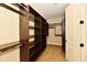 Walk-in closet with custom shelving and hanging rods offers ample storage at 7128 Trail Ridge Ln, Indianapolis, IN 46259