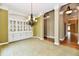Dining room featuring custom built-ins, chandelier lighting, and access to adjoining rooms at 7128 Trail Ridge Ln, Indianapolis, IN 46259