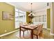 Cozy dining room with large windows, elegant chandelier, and built-in cabinets, ideal for Gathering gatherings at 7128 Trail Ridge Ln, Indianapolis, IN 46259