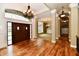 Elegant foyer featuring hardwood floors, a grand chandelier, and beautiful millwork at 7128 Trail Ridge Ln, Indianapolis, IN 46259