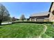 Charming home featuring a well-kept green lawn, flowering trees, and an attached garage at 7128 Trail Ridge Ln, Indianapolis, IN 46259