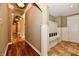 Elegant hallway with hardwood floors, archways, and built-in mudroom storage at 7128 Trail Ridge Ln, Indianapolis, IN 46259