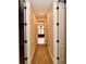 Hallway with neutral walls, carpet, and white trim leading to the bathroom at 7128 Trail Ridge Ln, Indianapolis, IN 46259