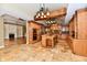 View of open kitchen and living room featuring custom cabinetry, an island, and stone tile flooring at 7128 Trail Ridge Ln, Indianapolis, IN 46259