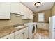 Convenient laundry room with granite counters, tile floor and ample cabinet space at 7128 Trail Ridge Ln, Indianapolis, IN 46259