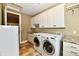 Bright laundry room features granite counters and tile floors at 7128 Trail Ridge Ln, Indianapolis, IN 46259