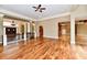 Open living room with hardwood floors, elegant pillars, and views into multiple rooms at 7128 Trail Ridge Ln, Indianapolis, IN 46259