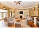 Staged living room featuring hardwood floors, fireplace with built-ins, and elegant finishes at 7128 Trail Ridge Ln, Indianapolis, IN 46259