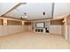 Finished basement with built-in media center and neutral carpeting at 7128 Trail Ridge Ln, Indianapolis, IN 46259