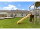 Spacious backyard with a wooden deck, playground, and well-maintained lawn, perfect for outdoor activities at 7219 Snider Ct, Indianapolis, IN 46221