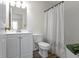 Clean bathroom with white vanity, toilet and shower featuring a stylish shower curtain at 7219 Snider Ct, Indianapolis, IN 46221