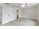 Bright bedroom with carpet flooring, ceiling fan and en-suite bathroom at 7219 Snider Ct, Indianapolis, IN 46221