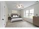 Inviting bedroom featuring a ceiling fan, a large window and carpet flooring at 7219 Snider Ct, Indianapolis, IN 46221