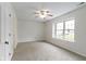 Bedroom features carpet flooring, a ceiling fan, and a large window at 7219 Snider Ct, Indianapolis, IN 46221