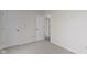 Bedroom featuring neutral paint, carpeted flooring, and two doors at 7219 Snider Ct, Indianapolis, IN 46221