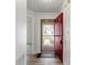 Bright foyer with a red front door, wood-look floors and view into an adjacent room at 7219 Snider Ct, Indianapolis, IN 46221