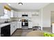 Well-lit kitchen with white cabinets, stainless steel range, and modern faucet at 7219 Snider Ct, Indianapolis, IN 46221