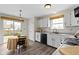 Eat-in kitchen featuring white cabinets, laminate floor and stainless steel appliances at 7219 Snider Ct, Indianapolis, IN 46221