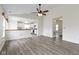 Open-concept living room flowing into the kitchen with wood-look floors and neutral walls at 7219 Snider Ct, Indianapolis, IN 46221