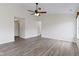 Bright living room with high ceilings, ceiling fan, and wood-look floors at 7219 Snider Ct, Indianapolis, IN 46221