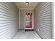 Covered porch with a red front door and neutral siding creating a welcoming entrance at 7219 Snider Ct, Indianapolis, IN 46221