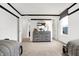Spacious bedroom showcasing a dresser with a mirror, a large window, and neutral-colored carpet at 7230 Estes Dr, Indianapolis, IN 46239
