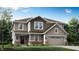 Charming two-story home with a two-car garage, landscaped yard, and inviting entrance at 7230 Estes Dr, Indianapolis, IN 46239