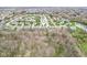 Location pin centered over a suburban neighborhood, backing onto a lush nature area and pond at 7501 Independence Dr, Zionsville, IN 46077