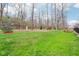 Large grassy backyard featuring mature trees, a storage shed, and a picnic table at 7501 Independence Dr, Zionsville, IN 46077