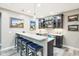 Basement bar area with a sleek counter, comfortable seating, modern cabinets, and decorative shelving at 7501 Independence Dr, Zionsville, IN 46077