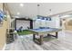 Entertaining basement featuring a pool table with modern lighting and golf simulator area at 7501 Independence Dr, Zionsville, IN 46077