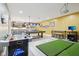 Spacious finished basement with an air hockey table, pool table, golf simulator, and a stylish wet bar at 7501 Independence Dr, Zionsville, IN 46077