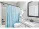 Bright bathroom with granite counters, white cabinets and a bathtub with a blue shower curtain at 7501 Independence Dr, Zionsville, IN 46077