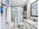 A bathroom featuring a shower/tub combo, cabinet storage, and vanity with granite countertop at 7501 Independence Dr, Zionsville, IN 46077