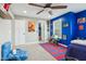 Comfortable bedroom featuring blue walls, neutral carpet, natural light, and a cozy reading nook at 7501 Independence Dr, Zionsville, IN 46077
