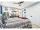 A nicely decorated bedroom featuring a full bed, ceiling fan, and closet space at 7501 Independence Dr, Zionsville, IN 46077