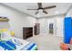 A bedroom featuring a surfboard-themed bed set, wooden fan, and ample closet space at 7501 Independence Dr, Zionsville, IN 46077