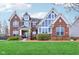 Beautiful two-story brick home with a well-manicured lawn and blue accents, perfect for Gathering living at 7501 Independence Dr, Zionsville, IN 46077