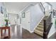 Welcoming foyer with hardwood floors, staircase, and natural light creates an inviting entry into the home at 7501 Independence Dr, Zionsville, IN 46077