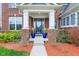 Inviting front porch with stately columns, potted plants, and a glass-paneled door, enhancing the home's curb appeal at 7501 Independence Dr, Zionsville, IN 46077